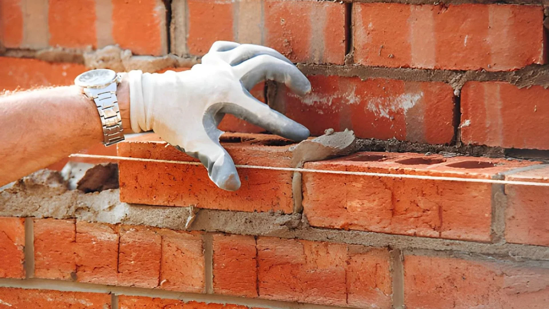 Chimney pointing contractor repairing mortar joints on NYC rooftop